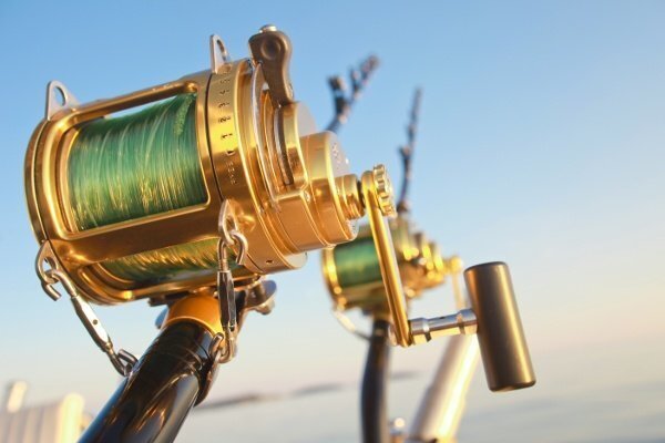 fishing_reels_and_rod_lit_by_sunset_95447152-128