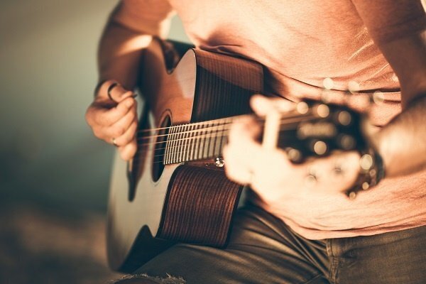 band_closeup_of_a_man_playing_a_guitar-2